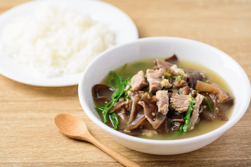 Spicy brown jelly mushroom soup with pork in a bowl eating with cooked rice, Local Thai food