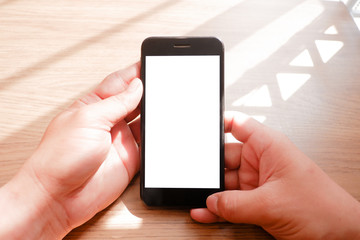 Mockup picture of business man’s hands holding smart phone with white blank screen in modern place
