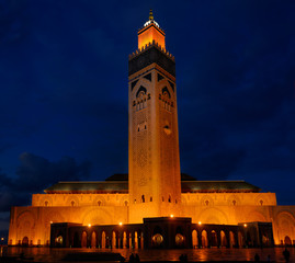 Fototapeta na wymiar Golden lights on Hassan II Mosque and minaret at night in Casablanca Morocco