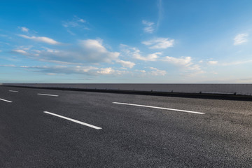 Fototapeta premium Skyline of Asphalt Pavement and Blue Sky and White Cloud