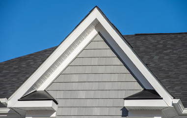 Plastic or wood white roof decoration gable, corbel, louver on a new construction luxury American...
