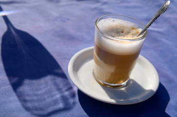 Noss Noss coffee and shadow of a wine glass on a outdoor table at Oualidia Morocco