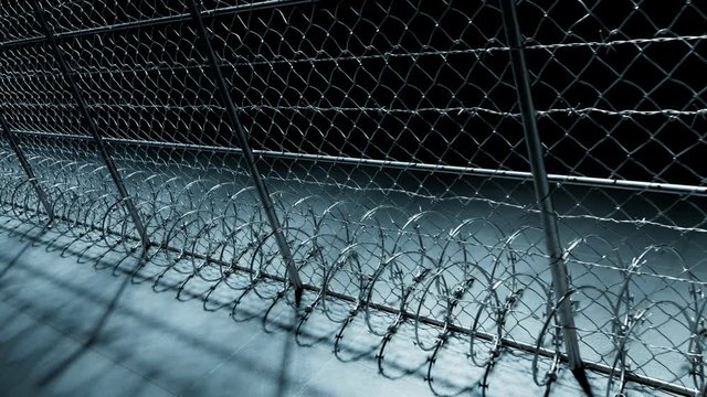 Endless footage showing the whole prison fence at night. Jail protection. 4k HD