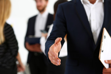 Businessman offer hand to shake as hello in office closeup. Serious business, friendly support service, excellent prospect, introduction or thanks gesture, gratitude, invite to participate concept