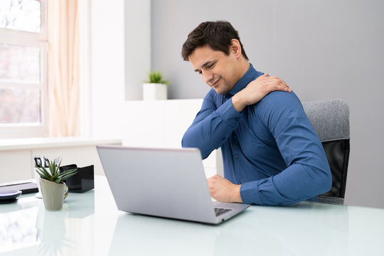 Mature Businessman Suffering From Shoulder Pain