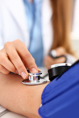 Female doctor arms make medic procedure closeup. Physical cure arterial beat exam tool nurse control and consult healthy lifestyle diagnosis therapeutist practice heal problem reception concept
