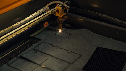 Laser cutting beam artificial leather High precision. Modern machine industrial technology of artificial leather cutting. CNC laser. Masterclass, workshop session