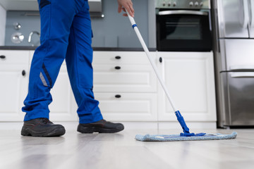 Man Mopping The Floor In Kitchen