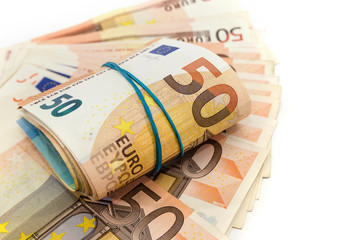 fifty euros rolled up. White background. Business concept.