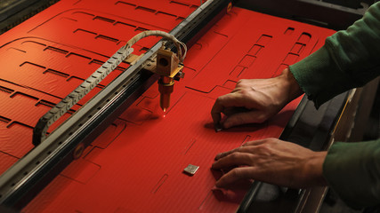 Laser cutting beam high precision on a paperboard. Modern machine industrial technology of...