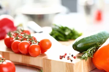 Foto op Canvas Healthy Organic Vegetables Cutting Board Photo. Small Cherry Tomatoes and Green Cucumber on Wooden Worktop. Aromatic Rosemary and Hot Pepper Spice. Organic Dieting Ingredient Horizontal Photography © H_Ko
