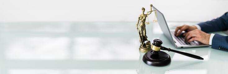 Close-up Of A Gavel On Desk