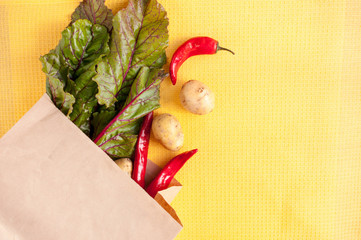 Vegetables in a paper bag , beets, potatoes, red peppers, space for text