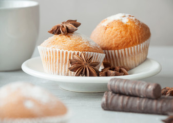 Delicious fresh muffins with a sweet anise on a white plate, ready to drink with coffee or tea. Sweet dessert