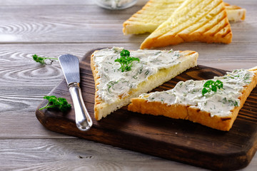 Fried bread on the grill with a crispy crust with garlic sauce, seasoned with herbs