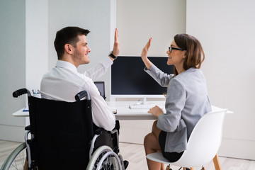 Disabled Businessman Giving High Five To His Partner