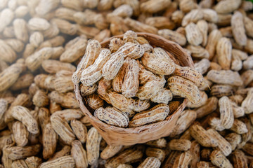 Plenty of dired peanuts in a basket.