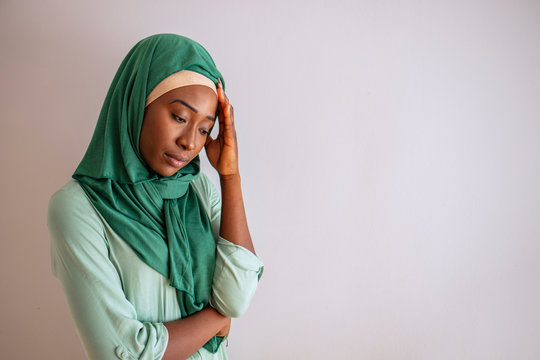 A Young Woman In Muslim Attire, Feeling Upset Disapointment, Worry, Sick, Headache. Young Female Feeling Headache, Suffering Migraine Symptom, Health Care, Stress. Woman Having Headache