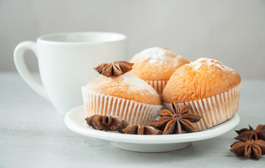 Delicious fresh muffins with a sweet anise on a white plate, ready to drink with coffee or tea. Sweet dessert