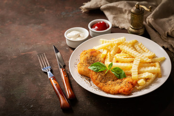 plate of chicken schnitzel and french fries