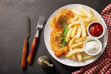 plate of chicken schnitzel and french fries, top view