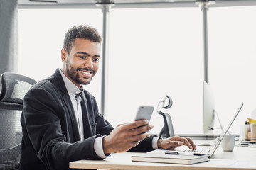 Businessman working on computer, Young man professional using laptop and smart phone in the office,...