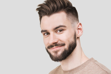 Closeup portrait of handsome smiling young man. Laughing joyful cheerful men studio shot. Isolated on gray background