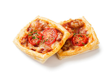 Puff pastry mini pies with cheese and tomatoes isolated on white background