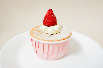 Delicious vanilla cupcake with fresh strawberry