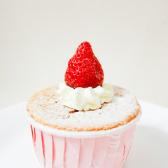 Delicious vanilla cupcake with fresh strawberry