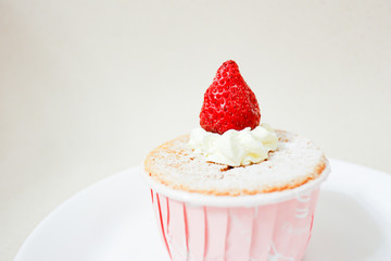 Delicious vanilla cupcake with fresh strawberry