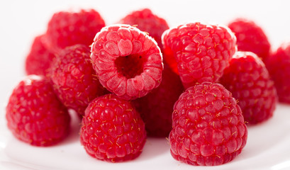 handful of raspberry berries on white background