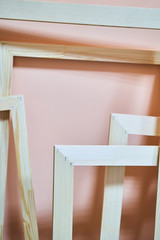 Naklejka na ściany i meble Wooden frames on a pink background. Abstraction. Frames for photos and paintings. Decoration