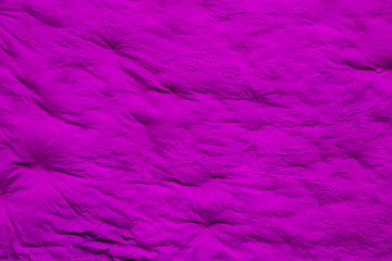 Background with bright purple surface. Smooth but uneven purple surface of the wall.