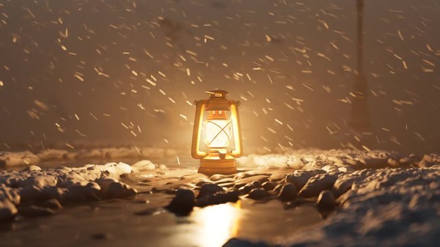 Old vintage hand lantern warming a frozen surrounding during a winter blizzard.