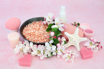 Fototapeta na wymiar Vegan skincare beauty treatment with spa, ex foliation & cleansing products with apple blossom flowers on pink background. Health care anti ageing concept.