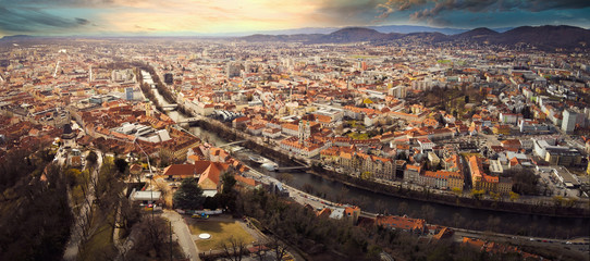 Aerial panorama view from Graz hill Schlossberg in Austria, cityscape with house roofs, mur river...