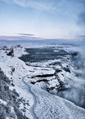 winter landscape with Gullfoss waterfall, cliff, lake and sky