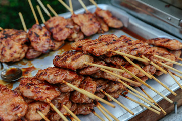 Grilled pork in skewers in the market.