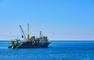 Trawl fishing boat near plan shot