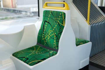 two vacant green seats on a vitorian tram public transport