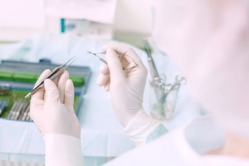 Microsurgical instruments and doctor hands. Doctor in operating room holding special ophthalmic surgeon tools.