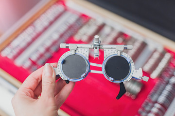 Optometrist trial frame in front of Ophthalmic Test Lens Kit. A universal messy tool for...