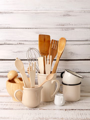 Baking kitchenware and baking products on white wooden background.