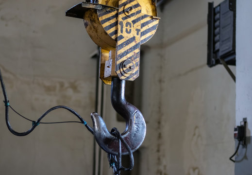 Industry. Metal hook with lifting cable mechanism. Close-up.