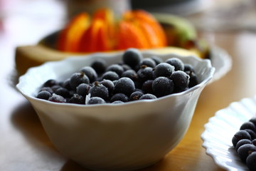  beryy of black currant in a white saucer