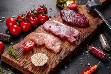 Fresh juicy steak of beef, pork and chicken with vegetables ready to cook