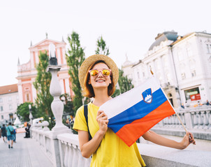 Woman tourist with slovenian flag in Ljubljana, Slovenia, Europe.