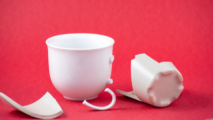 Broken Plate and dish or broken water glass on the on the red background The concept of accidents...
