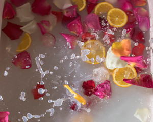 Fototapeta na wymiar romantic bath with white water and rose petals